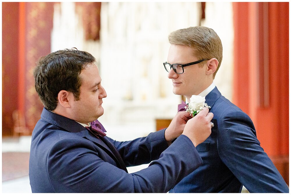 Groom getting his boutonniere on at A Holy Family Cathedral Wedding. 