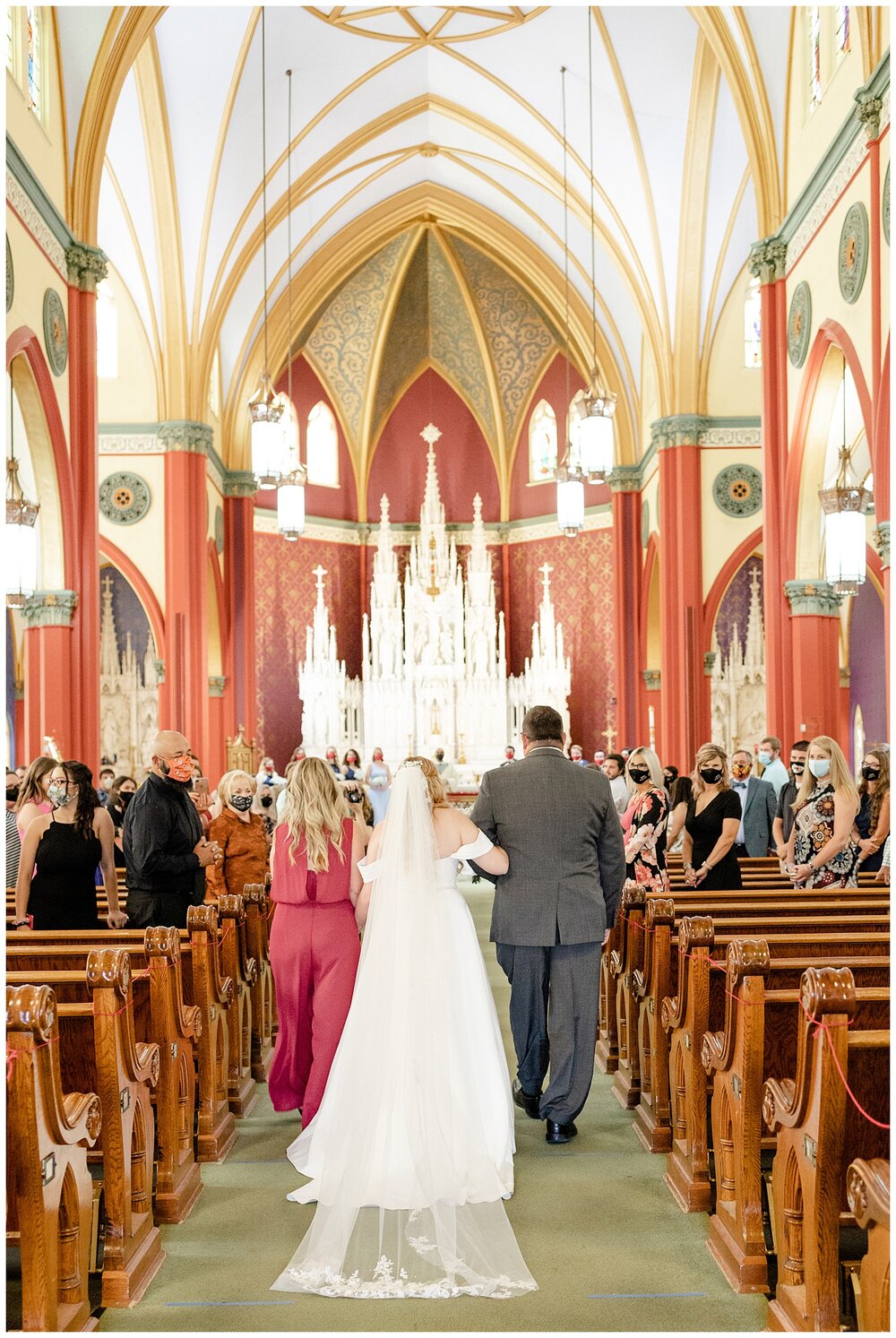 Bride's parent's walking her down the aisle at A Holy Family Cathedral Wedding.