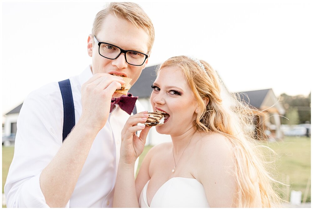 Bride and groom eating s'mores after A Holy Family Cathedral Wedding.