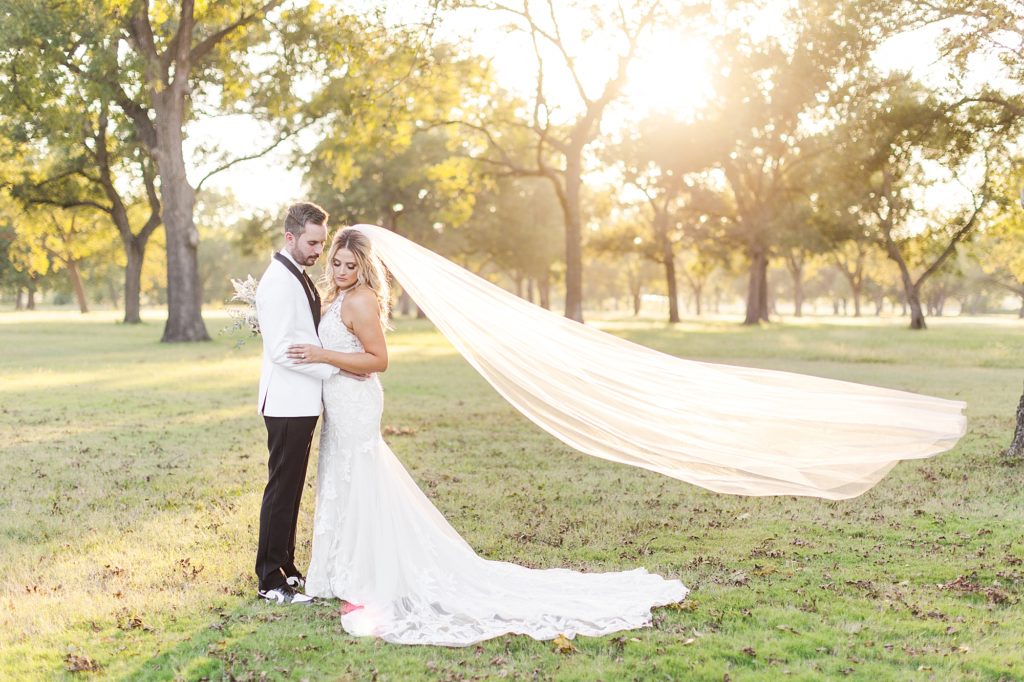 Flowing cathedral veil in the sunset on Pecandarosa Ranch wedding day.