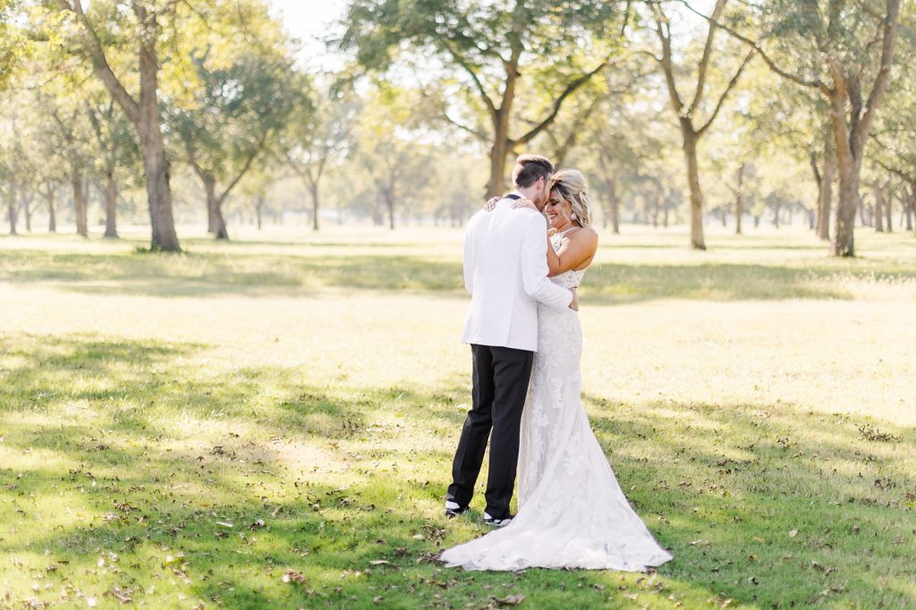 Couple having their first look in the pecan grove on their wedding day at Pecandarosa Ranch.