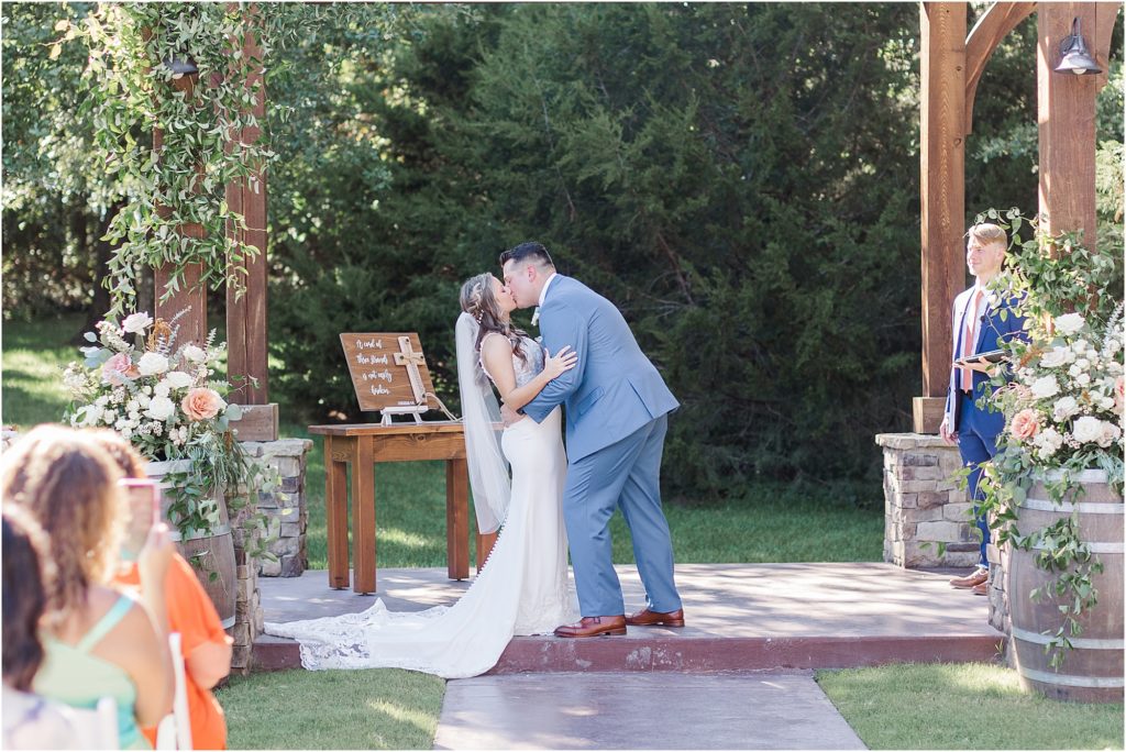 The couple sharing their first kiss as husband and wife at Eleven Oaks Ranch.