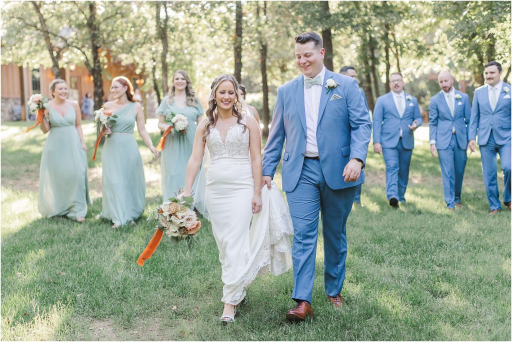 A wedding party taking a walk in the woods at Eleven Oaks Ranch in Luther, Oklahoma.