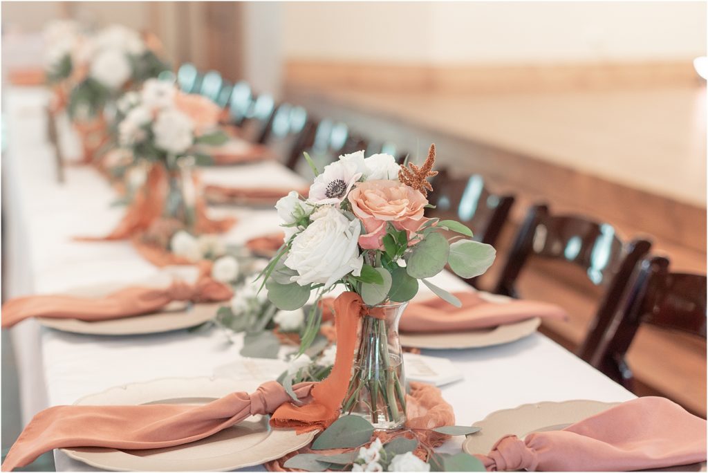 Floral table arrangements at wedding reception at Eleven Oaks Ranch.