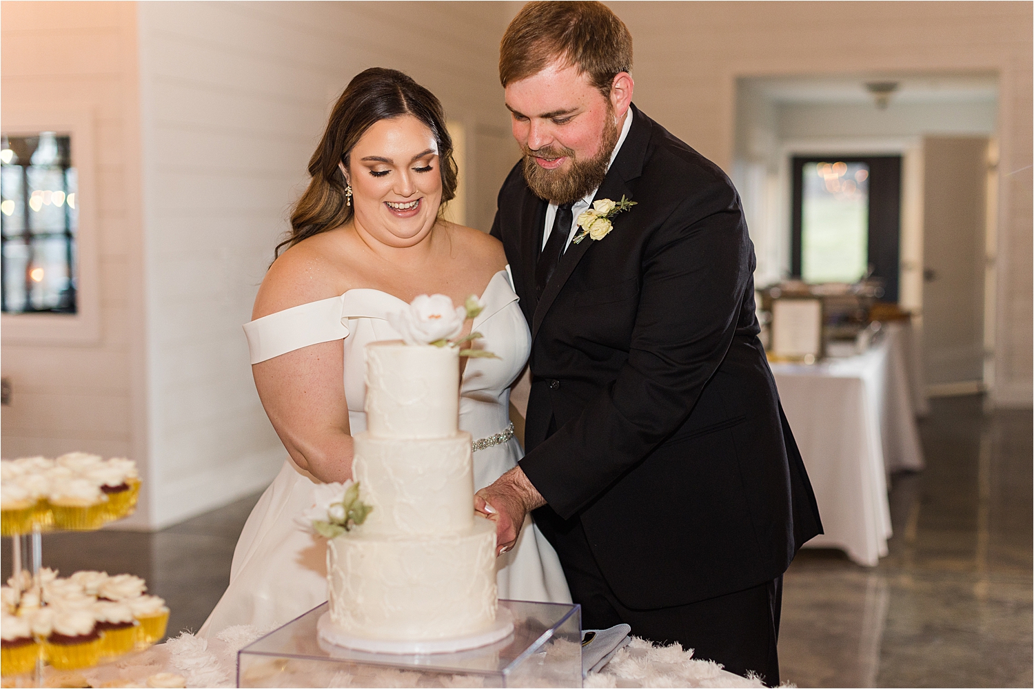 Brandi and Wade cutting their cake at their Dream Point Ranch Wedding reception.