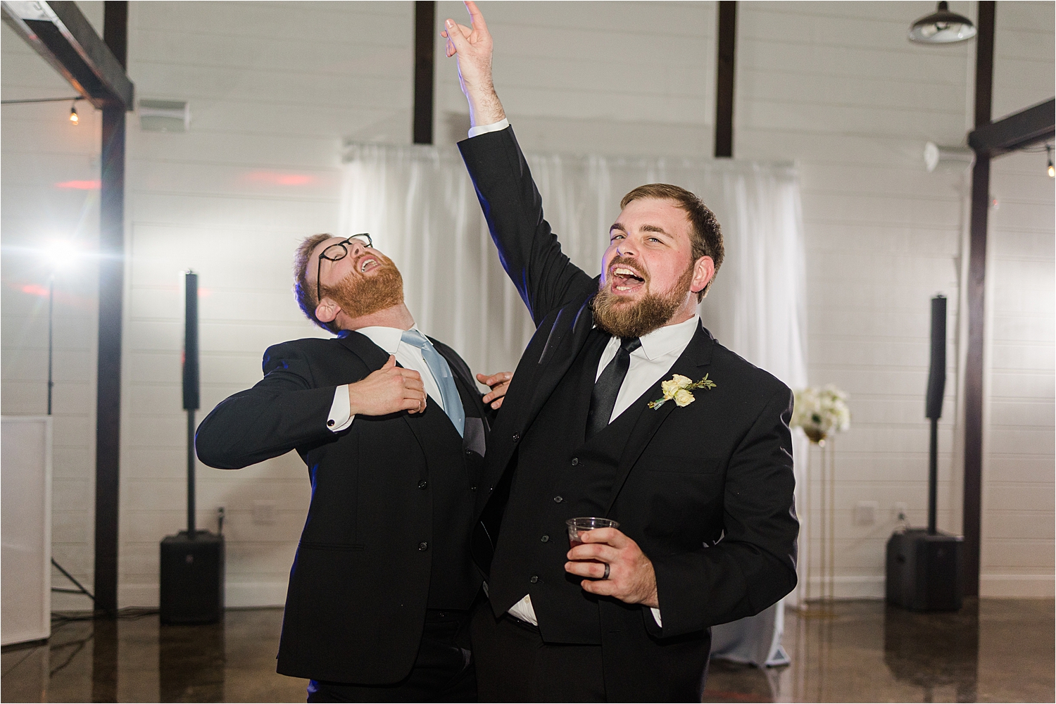 The groom and his groomsman dancing inside the wedding reception at Dream Point Ranch.