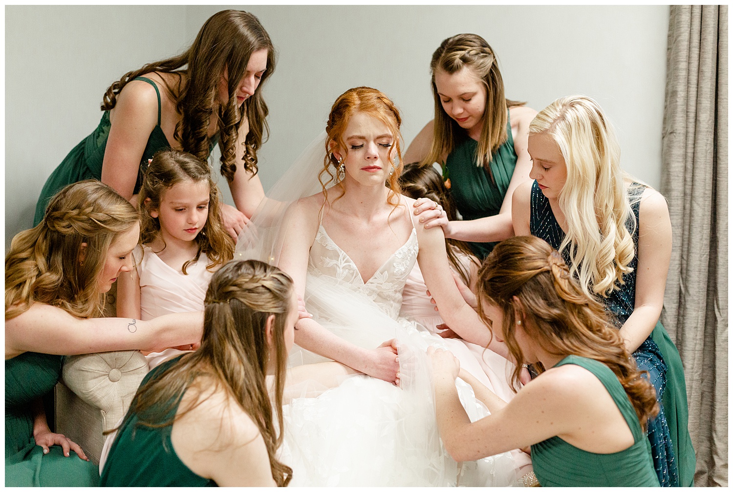 Bridesmaids praying over the bride on her wedding day.