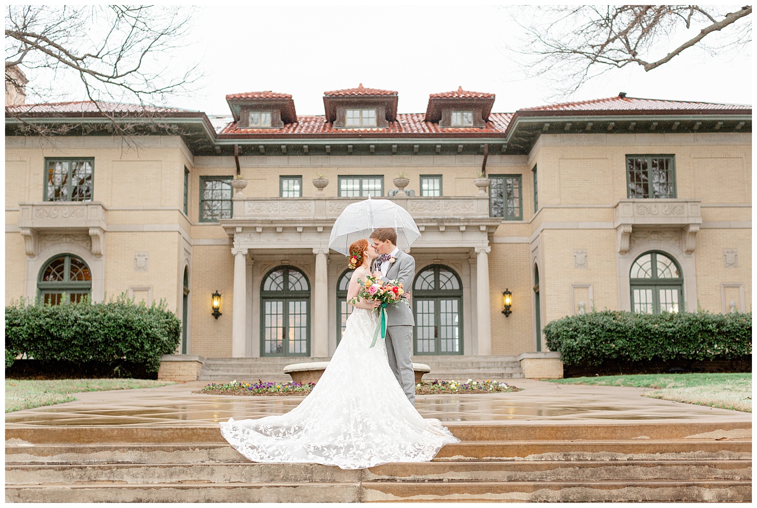 Bride and groom standing under an umbrella in the rain Mansion at woodward park during a spring wedding.
