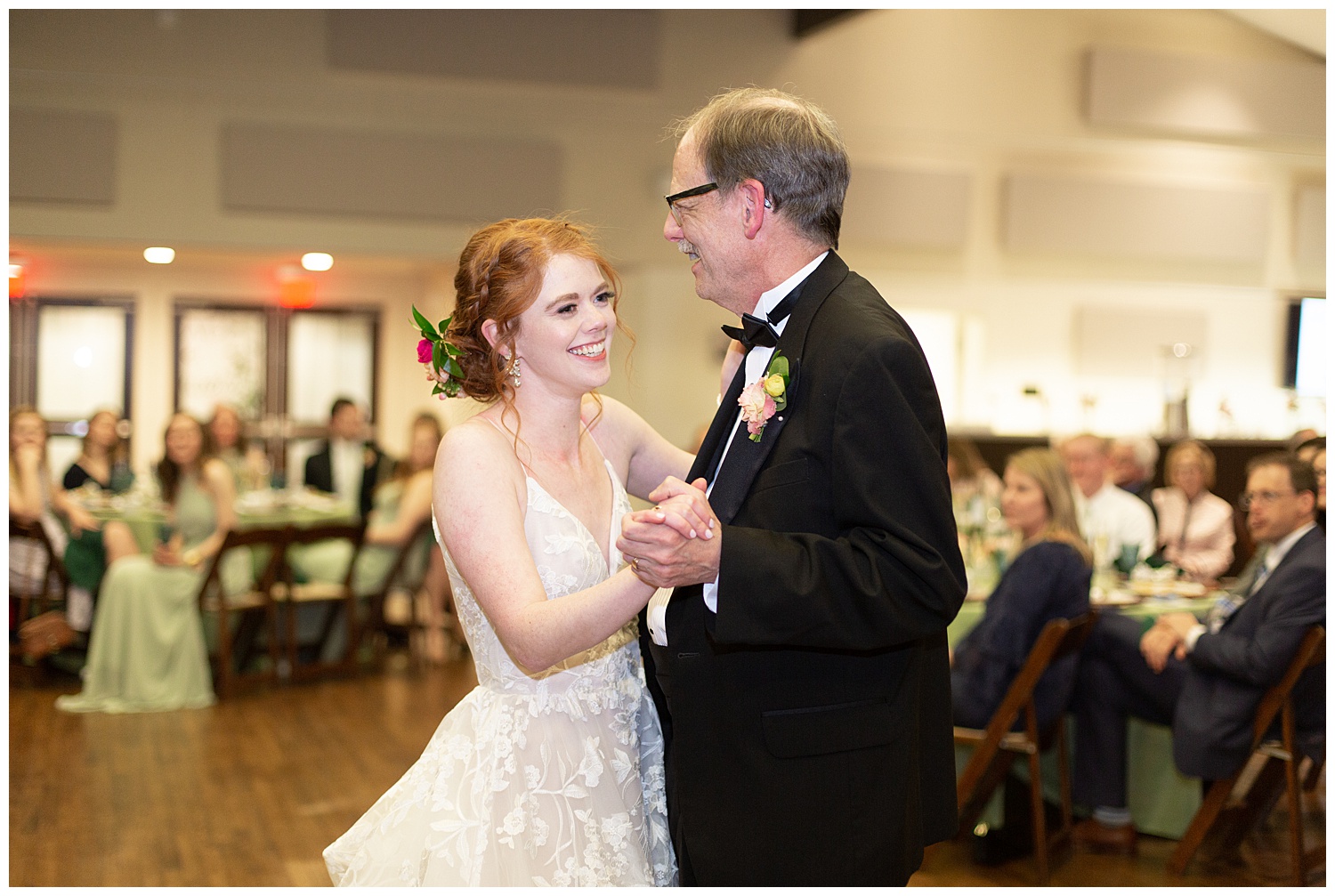 Bride sharing a first dance with her father after her rainy spring wedding.