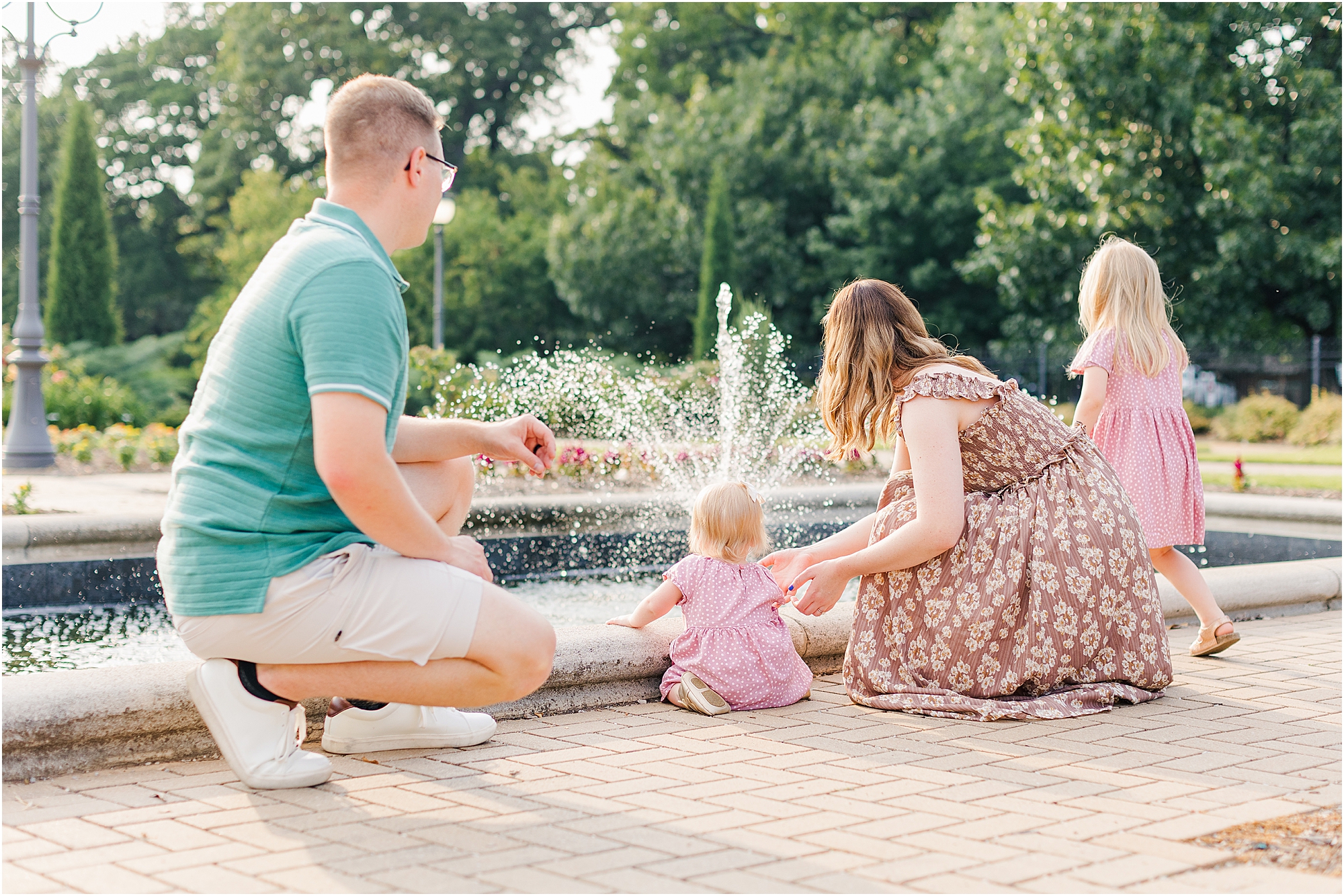 Family Watching the water fountain in the summer.