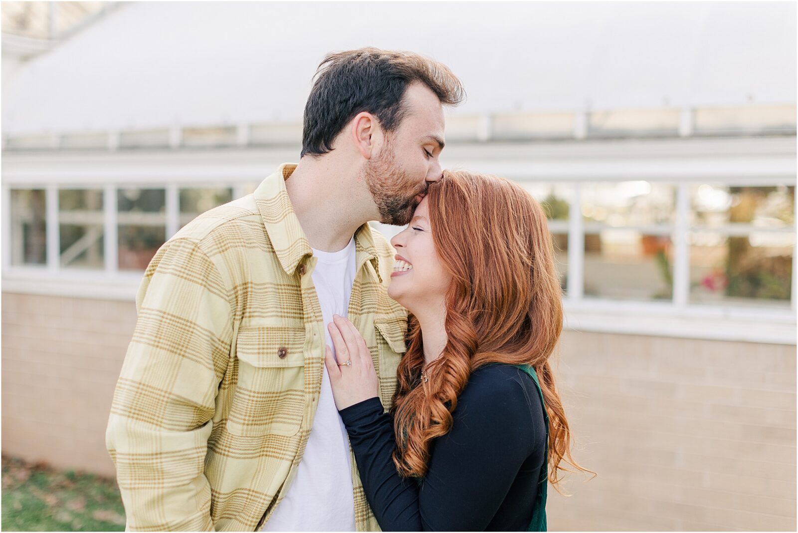 A garden engagement session at woodward park with the greenhouse.