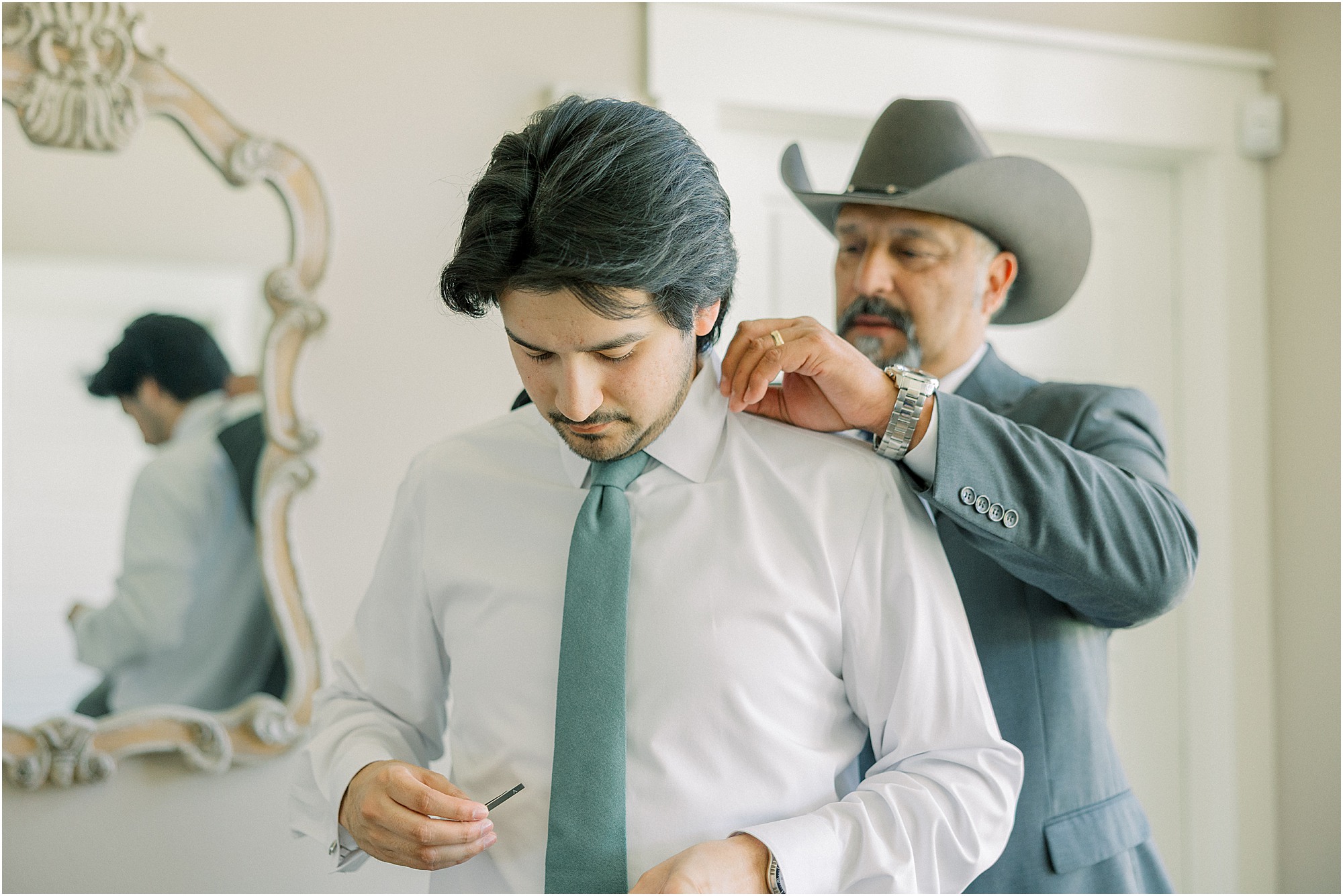 Groom's father helping him get ready for his wedding day at Lakeview Hills wedding venue.