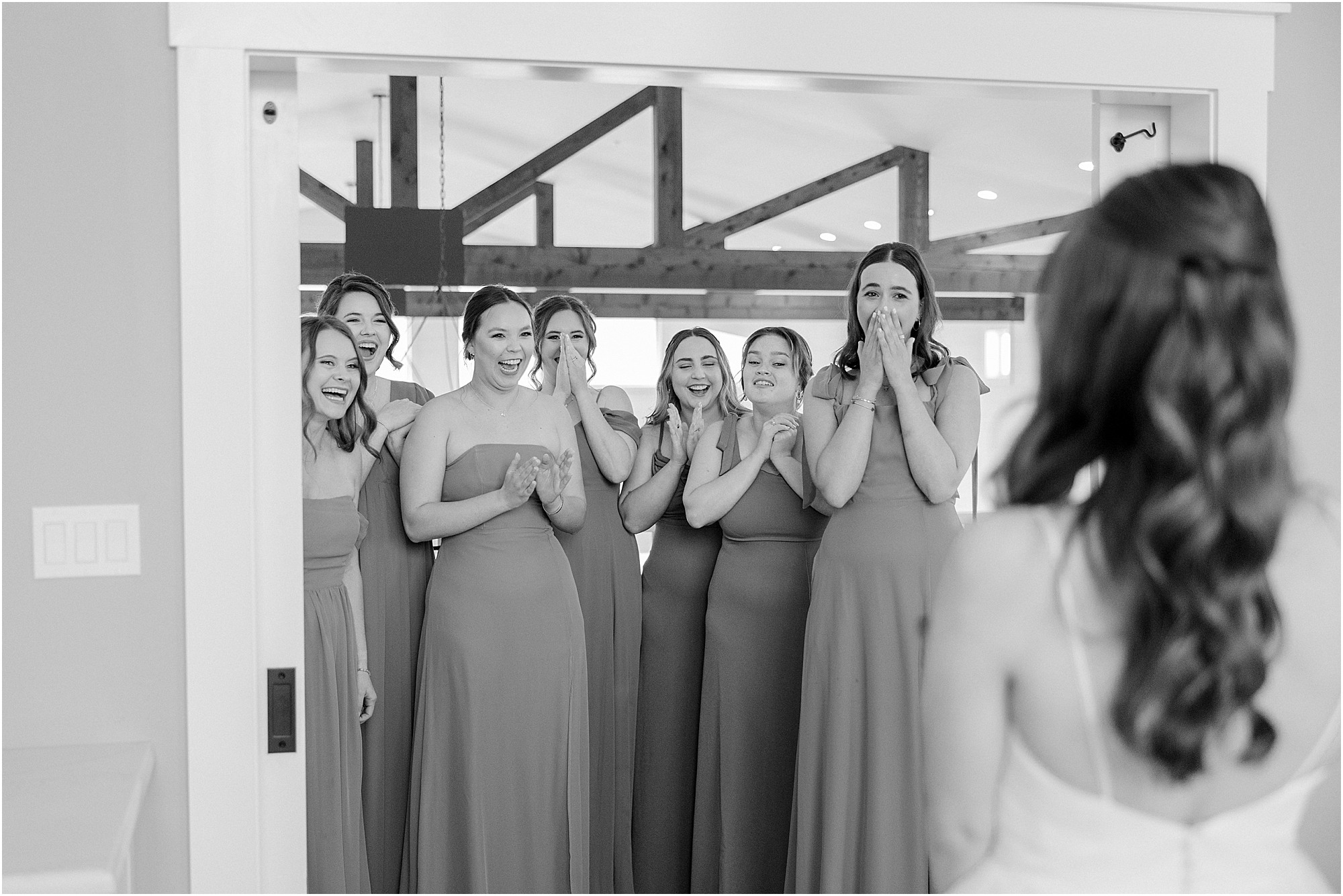 A bride and bridesmaids first look in the bridal suite at Lakeview Hills wedding venue.