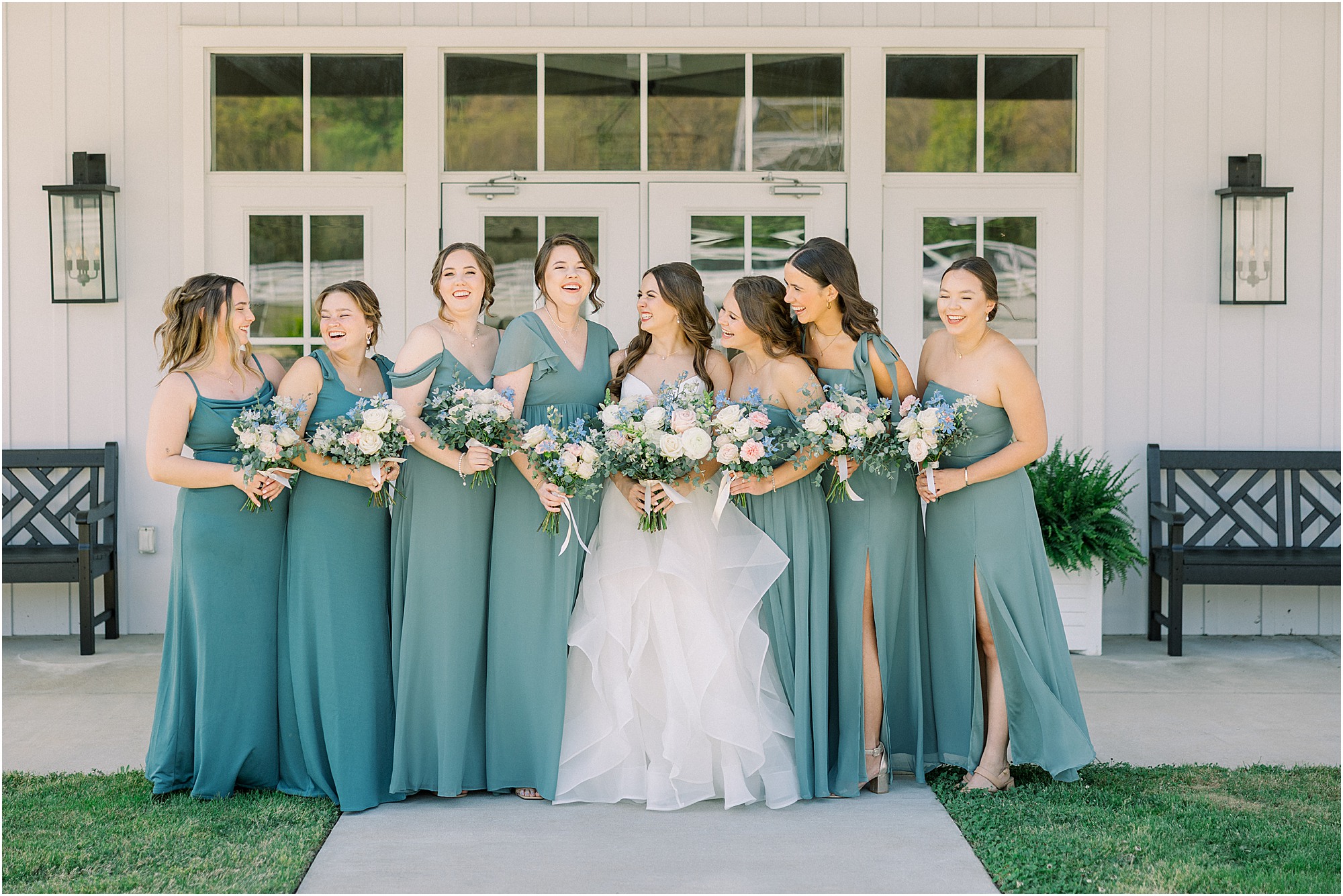 Bridesmaids in front of Lakeview Hills wedding venue on a glowy Spring day. 