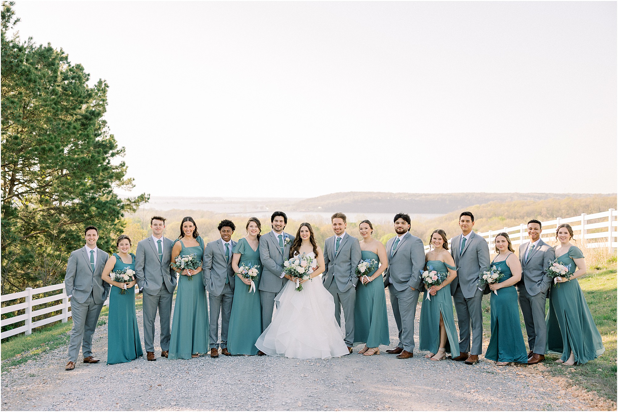 A full wedding party during golden hour, glowy sunset at Lakeview Hills wedding venue in the Spring time.