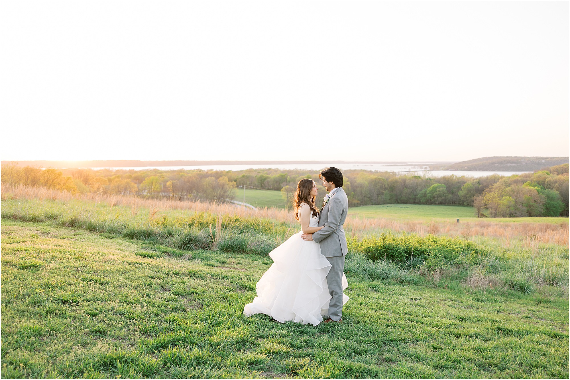 bride and groom embracing during a glowy sunset