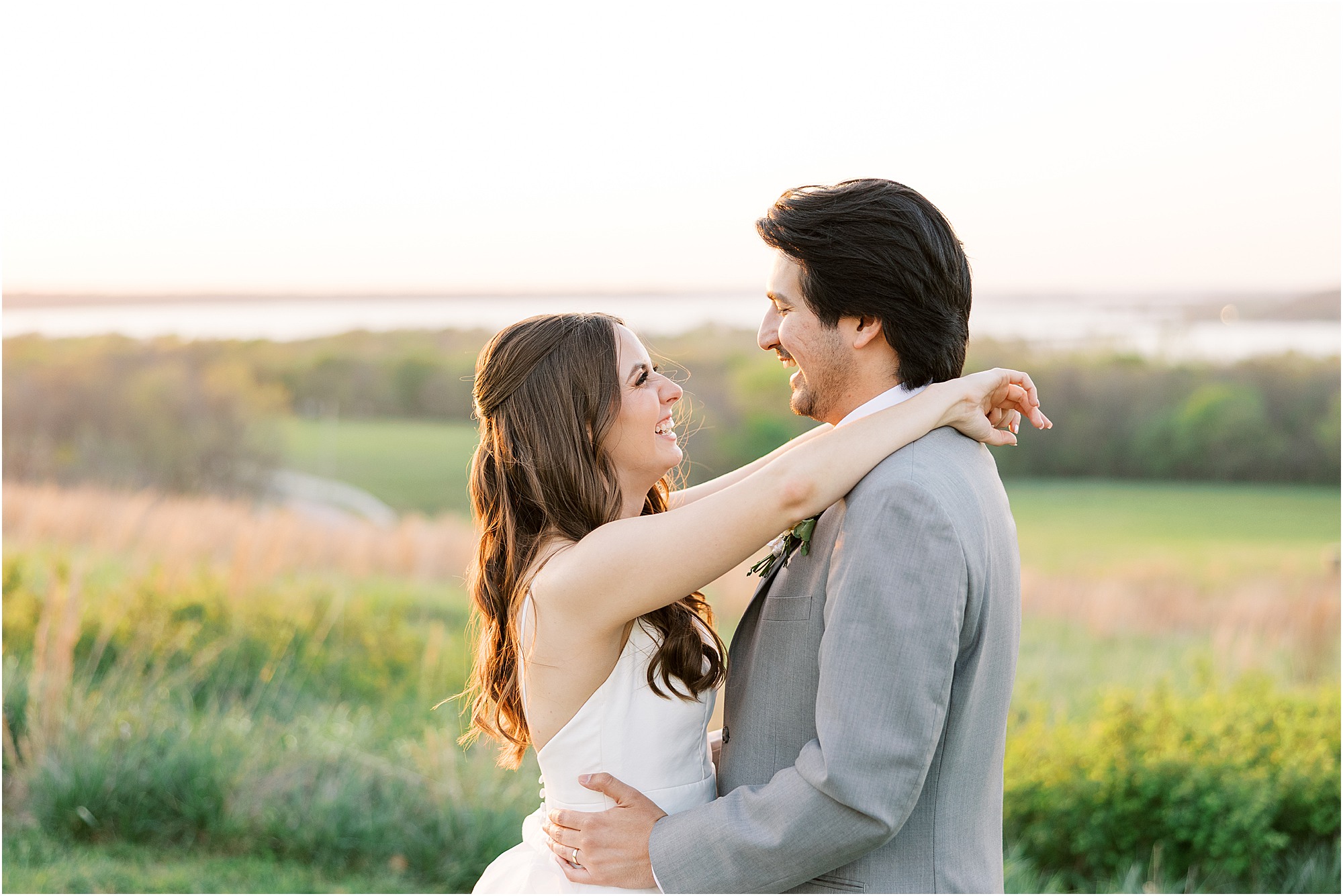Bride and groom enjoying the sunset on their wedding day at Lakeview Hills wedding venue with rolling hills and the sparkling lake.